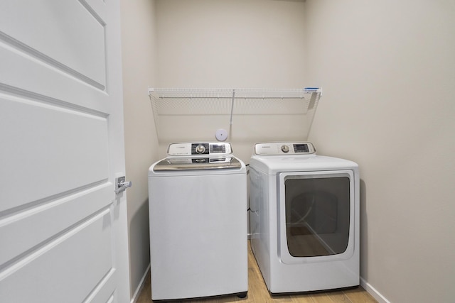 8113 S Safflower St, Cheney, WA 99004 - laundry room with washing machine and clothes dryer, light wood-type flooring, and baseboards