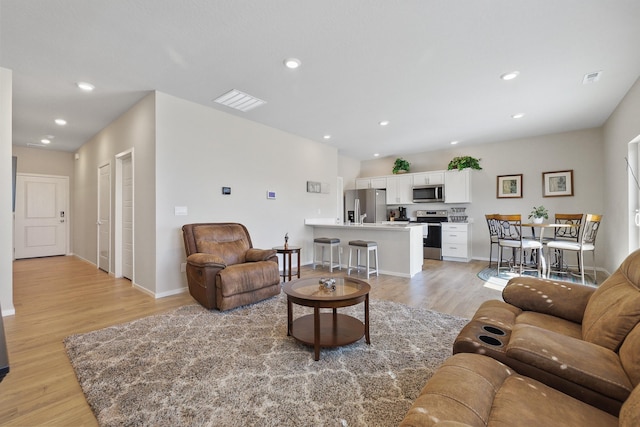 8113 S Safflower St, Cheney, WA 99004 - living room featuring light wood-style floors, baseboards, and recessed lighting