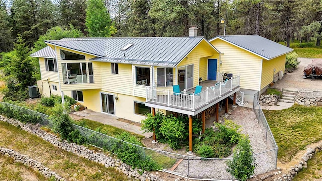 36918 N Valley Rd, Chattaroy, WA 99003 - rear view of property featuring a standing seam roof, metal roof, a patio, a deck, and driveway