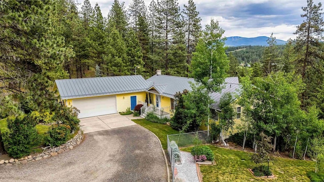 36918 N Valley Rd, Chattaroy, WA 99003 - ranch-style house featuring asphalt driveway, a garage, metal roof, a mountain view, and a standing seam roof