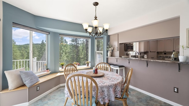 36918 N Valley Rd, Chattaroy, WA 99003 - dining space with a chandelier and baseboards
