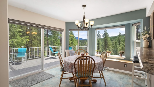 36918 N Valley Rd, Chattaroy, WA 99003 - dining room featuring a chandelier, concrete floors, healthy amount of natural light, and a mountain view
