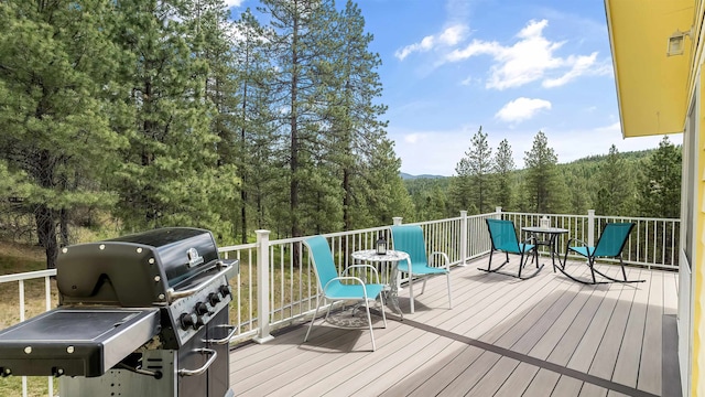 36918 N Valley Rd, Chattaroy, WA 99003 - wooden deck with grilling area, a view of trees, and outdoor dining area