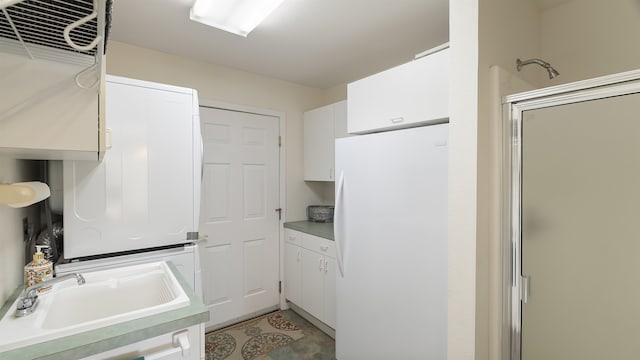 36918 N Valley Rd, Chattaroy, WA 99003 - kitchen featuring freestanding refrigerator, white cabinets, light countertops, a sink, and light tile patterned floors