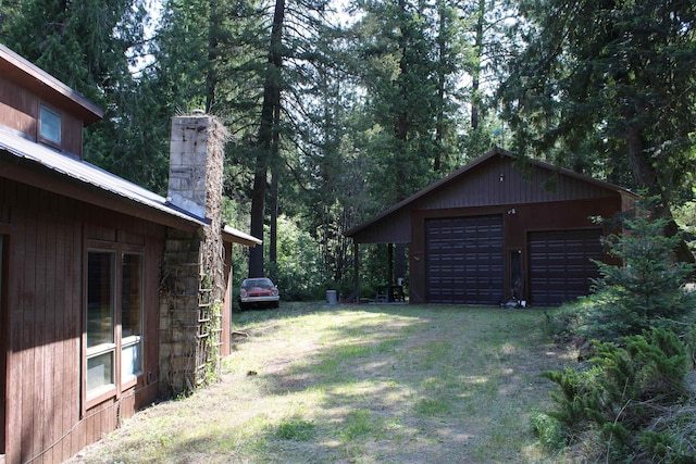42604 Hatch Rd, Deer Park, WA 99006 - view of green lawn with an outdoor structure, dirt driveway, and a detached garage