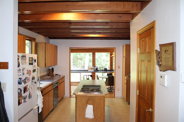 42604 Hatch Rd, Deer Park, WA 99006 - kitchen featuring freestanding refrigerator, stovetop with downdraft, dishwasher, brown cabinetry, and beamed ceiling