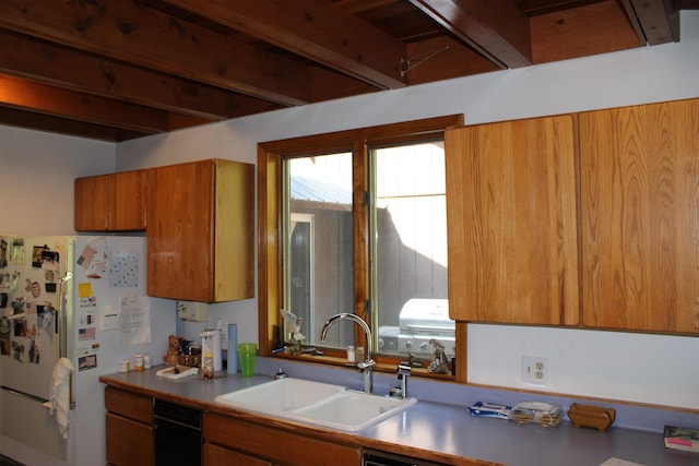 42604 Hatch Rd, Deer Park, WA 99006 - kitchen featuring a sink, brown cabinets, beam ceiling, freestanding refrigerator, and light countertops