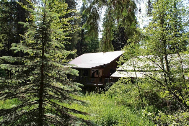 42604 Hatch Rd, Deer Park, WA 99006 - view of side of property with a deck, a forest view, and metal roof