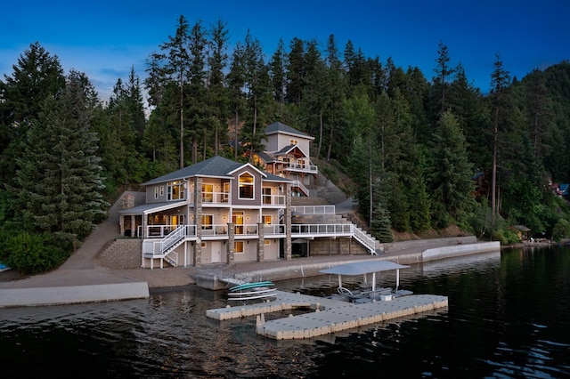 3907 E Pine Bay Way, Loon Lake, WA 99148 - back of house featuring stairs, a view of trees, and a water view