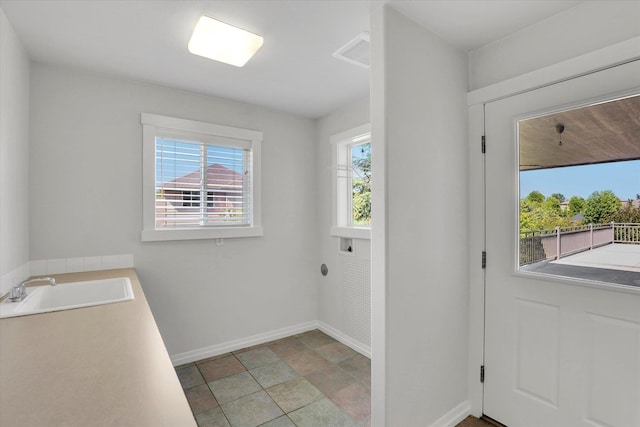 2306 W Rainier Ct, Spokane, WA 99208 - laundry room with baseboards and stone finish floors