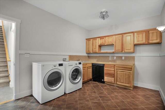 2306 W Rainier Ct, Spokane, WA 99208 - laundry room with washing machine and dryer, dark tile patterned flooring, and baseboards