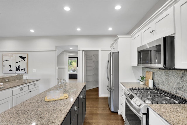 2306 W Rainier Ct, Spokane, WA 99208 - kitchen featuring stainless steel appliances, white cabinets, dark wood-style floors, recessed lighting, and light stone countertops