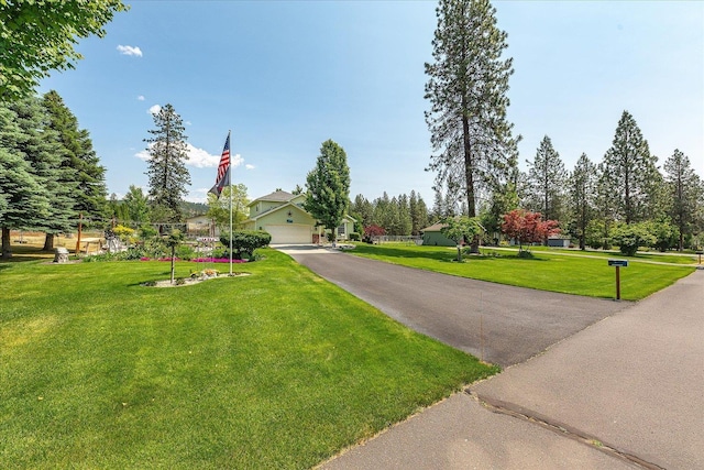 16324 N Cimmeron Ct, Nine Mile Falls, WA 99026 - obstructed view of property with a garage and a front yard
