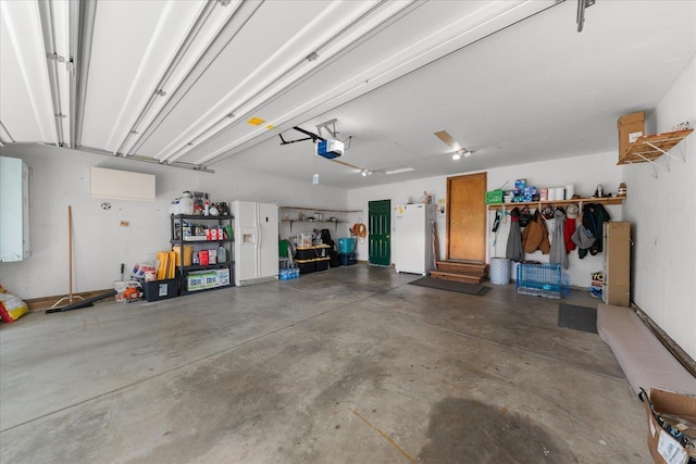 16324 N Cimmeron Ct, Nine Mile Falls, WA 99026 - garage featuring freestanding refrigerator and a garage door opener