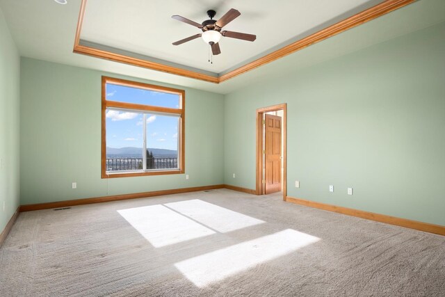 8518 E Black Oak Ln, Spokane, WA 99217 - spare room featuring a raised ceiling, carpet, baseboards, a ceiling fan, and ornamental molding