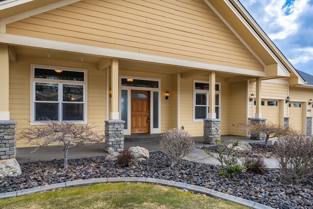 8518 E Black Oak Ln, Spokane, WA 99217 - property entrance featuring covered porch and a garage