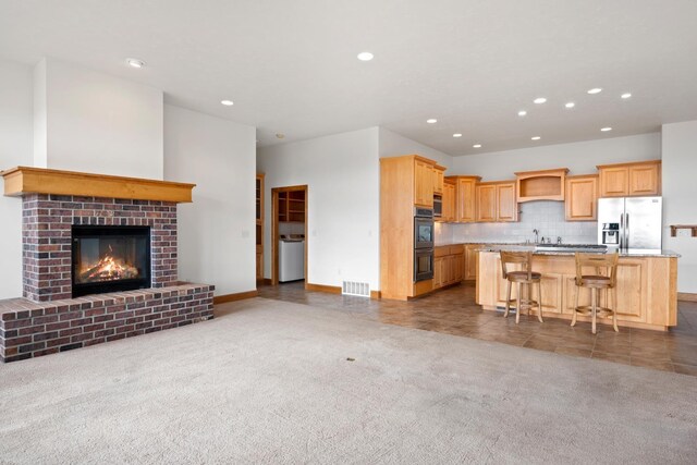 8518 E Black Oak Ln, Spokane, WA 99217 - kitchen with stainless steel appliances, recessed lighting, open floor plan, a kitchen island, and a breakfast bar area
