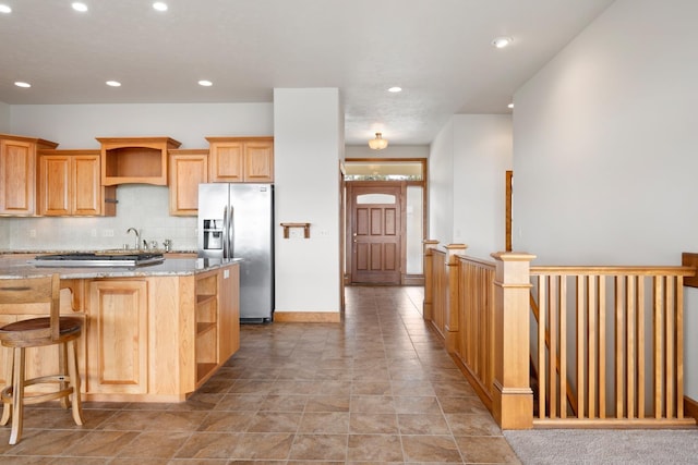 8518 E Black Oak Ln, Spokane, WA 99217 - kitchen with open shelves, stainless steel refrigerator with ice dispenser, light stone countertops, backsplash, and recessed lighting