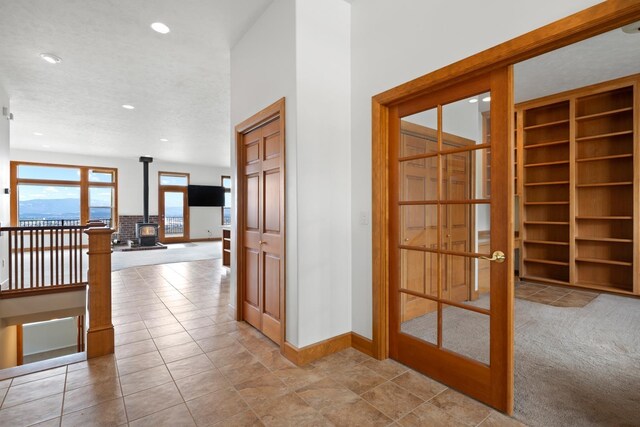 8518 E Black Oak Ln, Spokane, WA 99217 - hallway with baseboards, recessed lighting, french doors, built in shelves, and tile patterned flooring