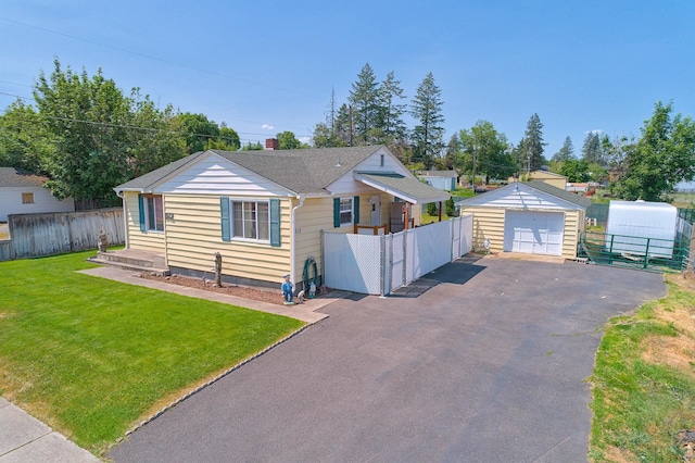 512 S Thierman Rd, Spokane Valley, WA 99212 - bungalow featuring a detached garage, driveway, and an outbuilding