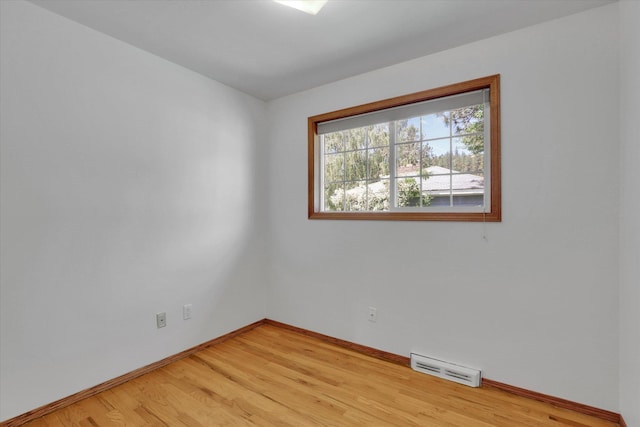 1010 W Westmont Way, Spokane, WA 99208 - empty room featuring a baseboard heating unit, baseboards, and light wood-style floors