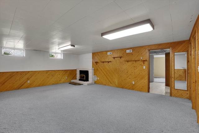 1010 W Westmont Way, Spokane, WA 99208 - basement featuring wood walls, carpet flooring, and a fireplace