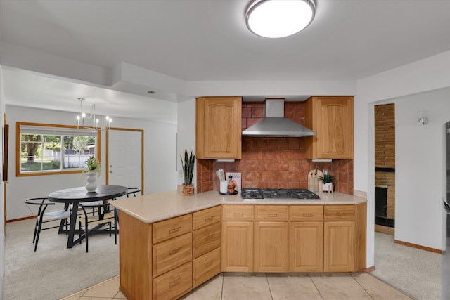 1010 W Westmont Way, Spokane, WA 99208 - kitchen featuring wall chimney range hood, gas stovetop, backsplash, light countertops, and light colored carpet