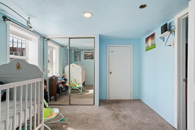 18 E Euclid Ave, Spokane, WA 99207 - carpeted bedroom featuring multiple windows, a closet, electric panel, and washer and dryer