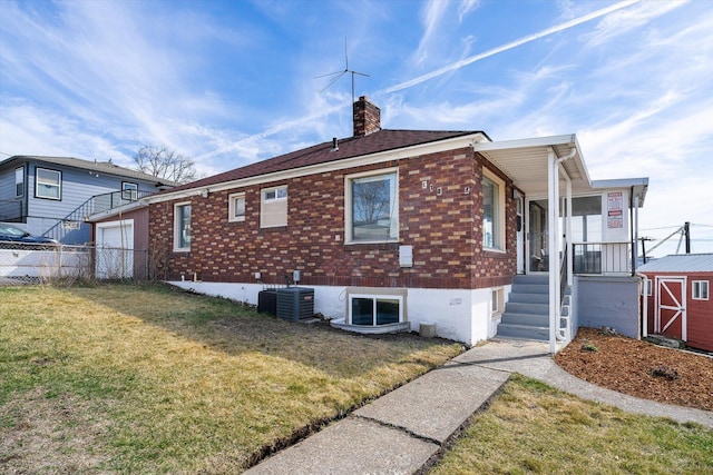 18 E Euclid Ave, Spokane, WA 99207 - view of property exterior with a chimney, an outdoor structure, central AC, and brick siding