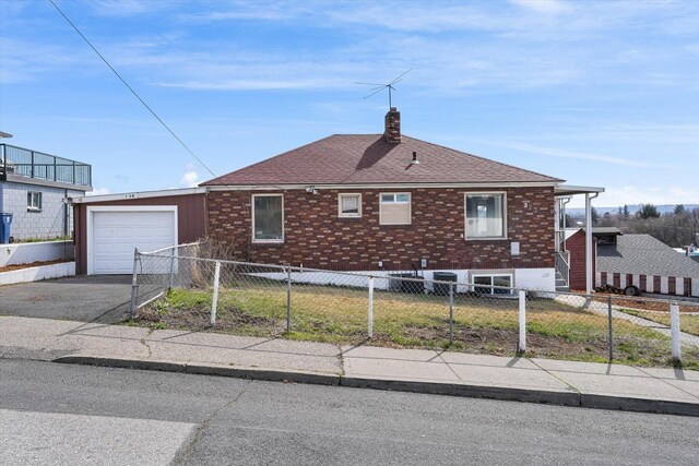 18 E Euclid Ave, Spokane, WA 99207 - view of property exterior featuring a garage, a chimney, driveway, a shingled roof, and brick siding
