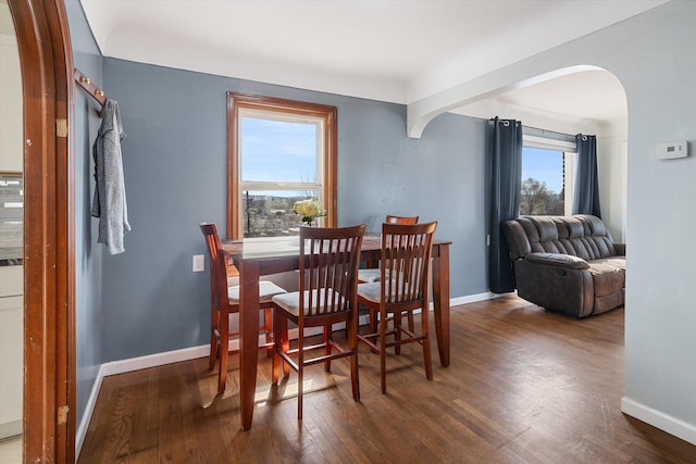18 E Euclid Ave, Spokane, WA 99207 - dining area featuring arched walkways, wood finished floors, and baseboards