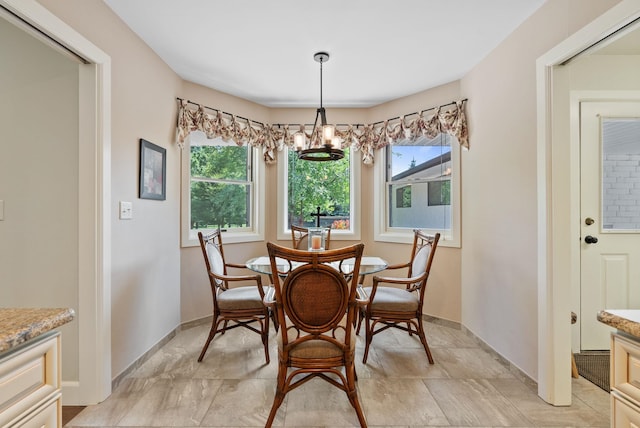 2203 W Strong Rd, Spokane, WA 99208 - dining room featuring a chandelier, healthy amount of natural light, and baseboards
