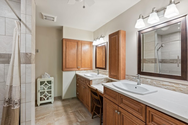 2203 W Strong Rd, Spokane, WA 99208 - bathroom featuring two vanities, a tile shower, a ceiling fan, and decorative backsplash