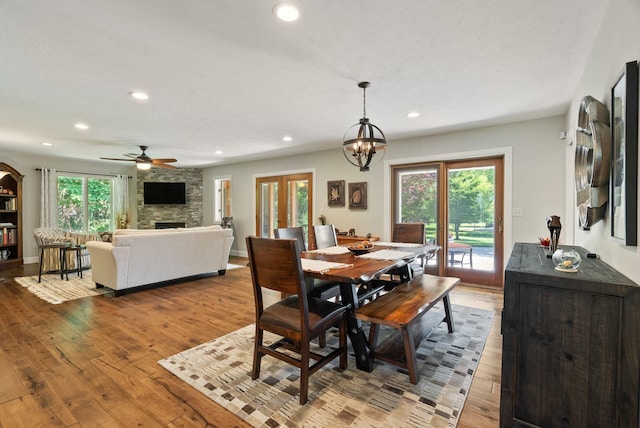 2203 W Strong Rd, Spokane, WA 99208 - dining space with a fireplace, hardwood / wood-style floors, recessed lighting, ceiling fan, and a chandelier