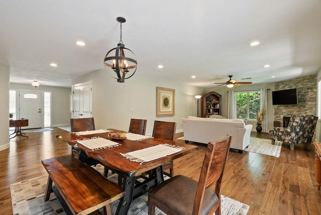 2203 W Strong Rd, Spokane, WA 99208 - dining space with hardwood / wood-style floors, a ceiling fan, baseboards, recessed lighting, and a stone fireplace
