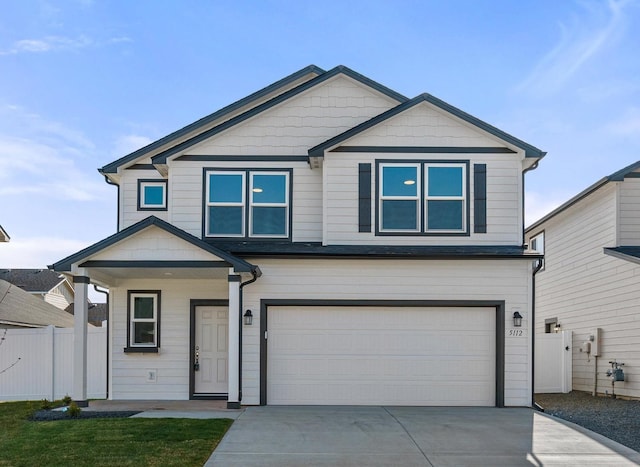 5112 N Silas Ln Unit 9/1Talent, Spokane Valley, WA 99216 - view of front facade featuring a garage, concrete driveway, and a porch