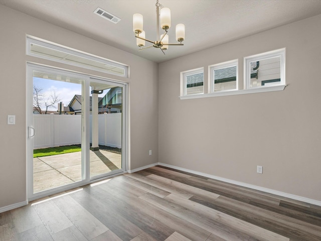 5112 N Silas Ln Unit 9/1Talent, Spokane Valley, WA 99216 - empty room with a chandelier, wood finished floors, and baseboards