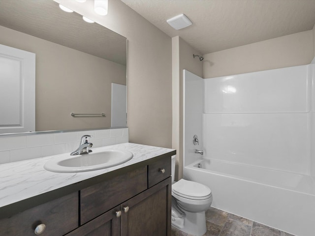 5112 N Silas Ln Unit 9/1Talent, Spokane Valley, WA 99216 - full bathroom featuring vanity, backsplash, washtub / shower combination, toilet, and stone finish flooring