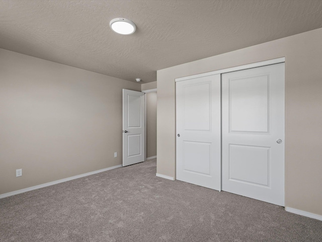 5112 N Silas Ln Unit 9/1Talent, Spokane Valley, WA 99216 - unfurnished bedroom with carpet floors, baseboards, a closet, and a textured ceiling
