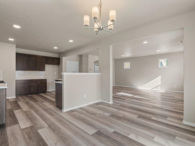 5112 N Silas Ln Unit 9/1Talent, Spokane Valley, WA 99216 - kitchen featuring dark brown cabinets, light wood-style floors, light countertops, recessed lighting, and decorative backsplash