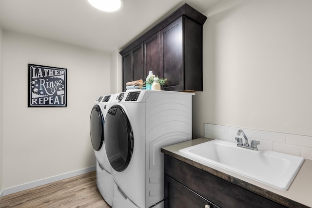 1638 W 68th Ave Unit 1/2Talent, Spokane, WA 99224 - washroom with separate washer and dryer, cabinet space, light wood-type flooring, and baseboards
