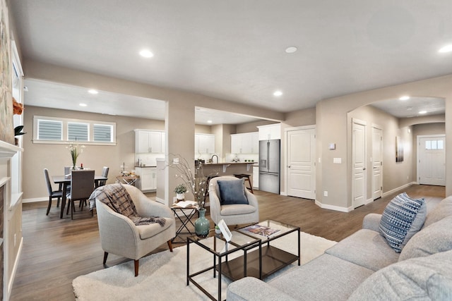 1638 W 68th Ave Unit 1/2Talent, Spokane, WA 99224 - living room featuring arched walkways, wood finished floors, baseboards, and recessed lighting