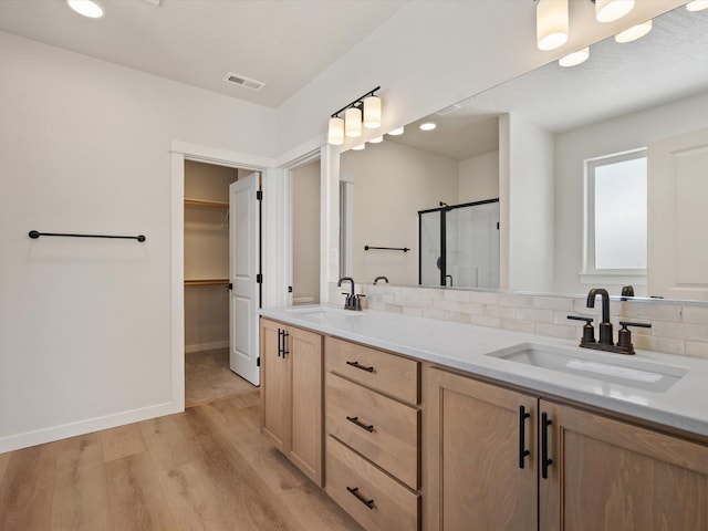 1438 W 67th Ave Lot 5Block 3, Orchard, Spokane, WA 99224 - bathroom with wood finished floors, double vanity, backsplash, a shower stall, and a spacious closet