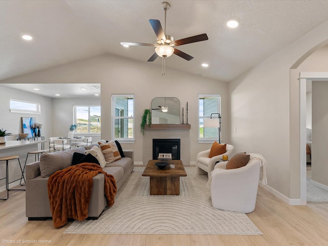 1438 W 67th Ave Lot 5Block 3, Orchard, Spokane, WA 99224 - living area with lofted ceiling, light wood finished floors, arched walkways, ceiling fan, and a fireplace