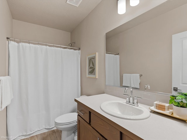 1438 W 67th Ave Lot 5Block 3, Orchard, Spokane, WA 99224 - full bath featuring decorative backsplash, vanity, toilet, wood finished floors, and a shower with shower curtain