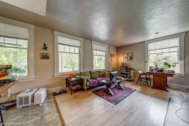 1611 W 9th Ave, Spokane, WA 99223 - living area with a textured ceiling, wood finished floors, and baseboards