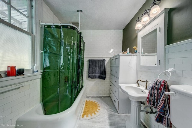 1611 W 9th Ave, Spokane, WA 99223 - bathroom with tile walls, shower / tub combo with curtain, toilet, and tile patterned floors