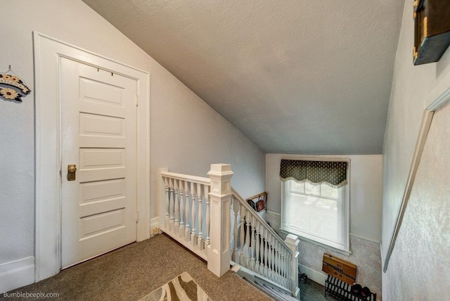 1611 W 9th Ave, Spokane, WA 99223 - staircase featuring vaulted ceiling, carpet flooring, and a textured ceiling