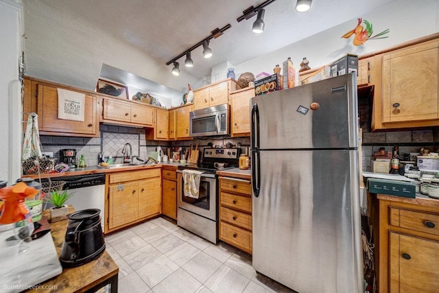 1611 W 9th Ave, Spokane, WA 99223 - kitchen with stainless steel appliances, a sink, tasteful backsplash, light tile patterned flooring, and light countertops