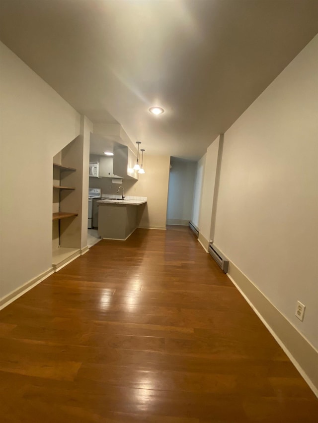 1621 W 9th Ave, Spokane, WA 99223 - unfurnished living room with dark wood-style flooring, a sink, baseboards, a baseboard heating unit, and built in features